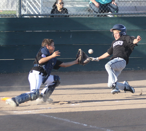 Stephen Geyer attempts to score from 1st base on a hit to deep right field.  Catcher Mikian Pickerill is receiving the throw and was able to tag him out.  This took place in Granada Little League Majo