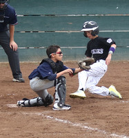 Jacob Sanchez of the Twins catches the throw from the 2nd baseman and is about to make the tag on Parker Warner of the Rockies in Granada Little League AAA division action.  Parker was able to beat th