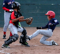 Justin Levine slides into home as Noah Olmos prepares to apply the tag during a Granada Little League AAA game between the Red Sox and Angels.  Justin was out in a very close play.