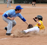 Jack Taggart slides safely back into 3rd base as Dominic Peri applies the tag in a Granada Little League Majors game between the Pirates and Royals.