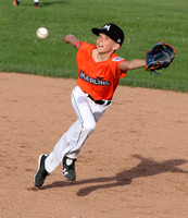 Second baseman Ayden Duffin of the Marlins reaches for a line drive in a Granada Little League Major’s game against the Giants.
