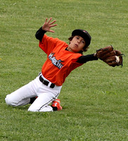Drew Hansen runs in and makes a catch on a short fly ball in a Granada Little League Major’s game between the Marlins and the Royals.