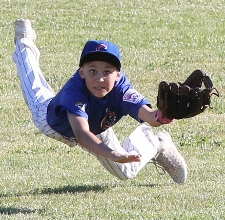 Center fielder Cole Camilleri dives for a fly ball in a Granada Little AAA Game between the Cubs and the Pirates.
